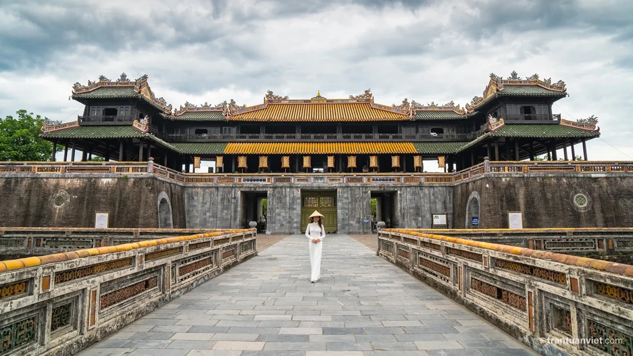 Hue citadel with Vietnamese girl in ao dai and conical hat